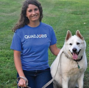 Student with Quad Job shirt and dog.